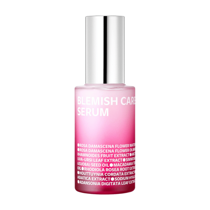 En ensam flaska Blemish Care Serum med en övertonad rosa design och silverfärgad kork, stående mot en vit bakgrund. Texten på flaskan listar ingredienser som bland annat rosenvatten, oljor och extrakt, tryckt i vitt på framsidan.