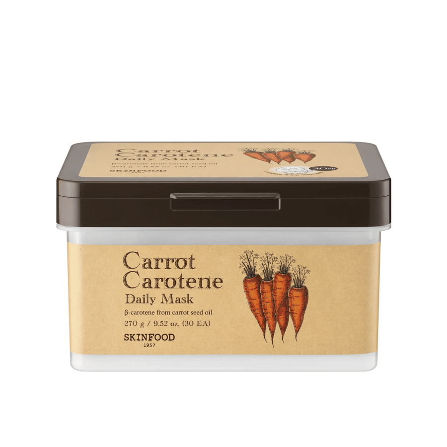 En förpackning "Carrot Carotene Daily Mask" från SKINFOOD, innehållande 30 ansiktsmasker. Produkten är berikad med β-karoten från morotsfröolja och är designad för dagligt bruk. Förpackningen är robust med en vintage-inspirerad etikett som framhäver morötterna som huvudingrediens.